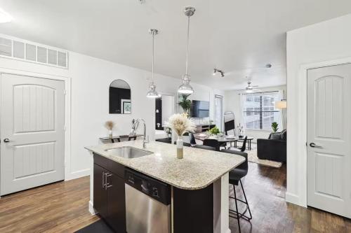 a kitchen and living room with a sink and a counter at Modern 2B Close to The Star Toyota HQ Legacy West in Frisco