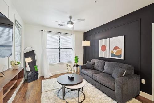 a living room with a couch and a table at Modern 2B Close to The Star Toyota HQ Legacy West in Frisco