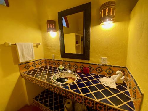 a bathroom with a sink and a mirror at Luna - Casa MoJo's delightful 1BR, kitchen, pool in Sayulita
