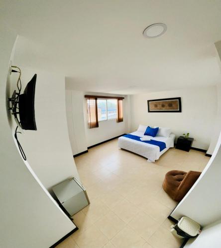 a bedroom with a bed and a couch at Hotel Cristal Plaza in Popayan