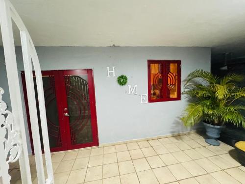 two red doors and a potted plant in a room at Tulli Private house in San Juan in San Juan