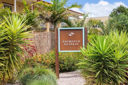 a sign in front of a garden with plants at Baywatch Retreat Augusta in Augusta
