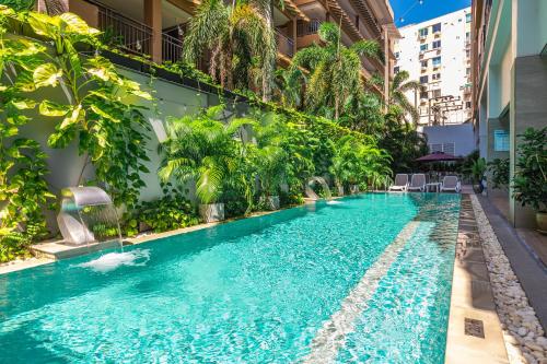 a swimming pool in the middle of a building at WOOVO Phuket Patong - by Swandor in Patong Beach