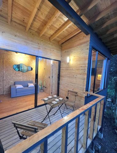 a deck of a cabin with a couch and a table at Boheme Cabin in Medellín