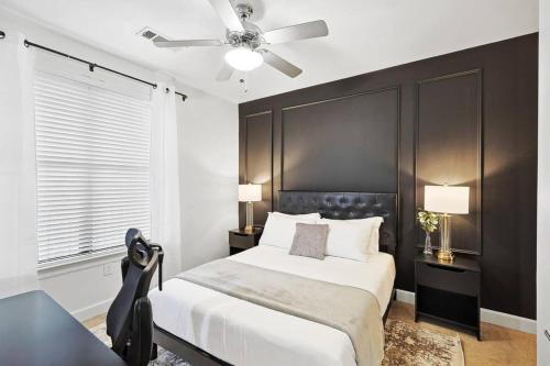 a bedroom with a bed and a ceiling fan at Lux 1B with Pool Near The Star, Legacy West & Toyota in Frisco