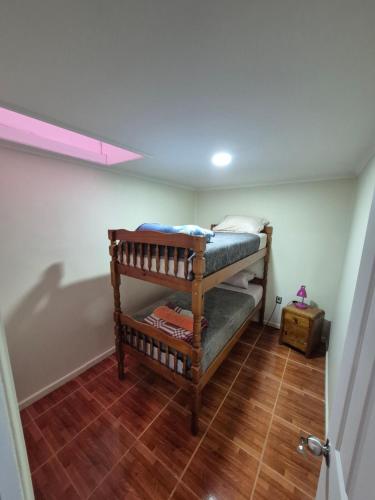 a room with a bunk bed in a room at Departamentos H&G in Punta Arenas