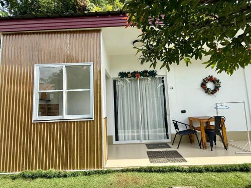 a house with a table and a window at Ivorys Guesthouse in Panglao
