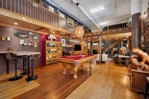 a billiard room with a pool table and a loft at St. Vincent Lofts in Los Angeles