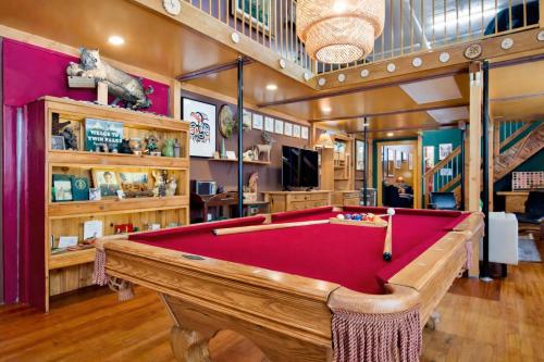 a billiard room with a red pool table at St. Vincent Lofts in Los Angeles