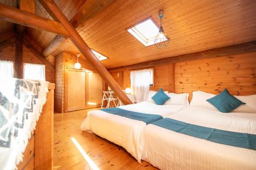 a bedroom with a bed in a wooden cabin at Awaji Seaside Log House - Vacation STAY 14164 in Awaji