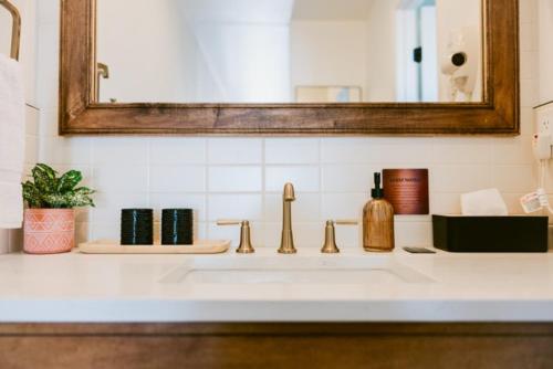 a bathroom counter with a sink and a mirror at Angoria Hotel in San Angelo