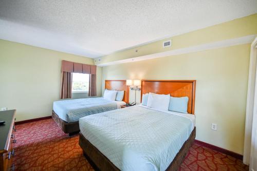 a hotel room with two beds and a television at Beachfront Condo with Stunning View Multiple Pools on BV 7th Floor in Myrtle Beach