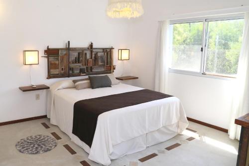 a bedroom with a large bed in a room with a window at Alma de La Pedrera - in La Pedrera