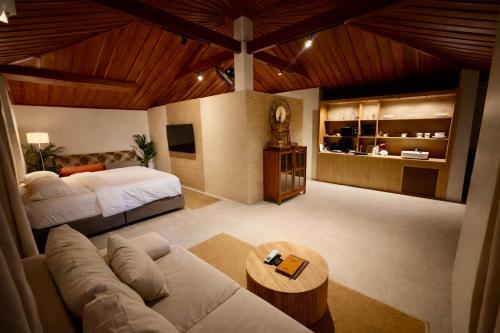 a large room with a bed and a couch at Tulum Villa Resort Koh Samui in Bophut 