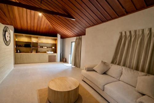 a living room with a couch and a wooden ceiling at Tulum Villa Resort Koh Samui in Bophut 