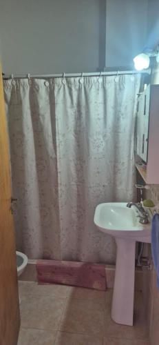 a bathroom with a shower curtain and a sink at Duplex Playa in Santa Clara del Mar
