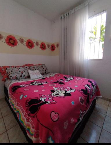 a bedroom with a hello kitty blanket on a bed at Casa de Temporada 5 Estrelas in Olímpia