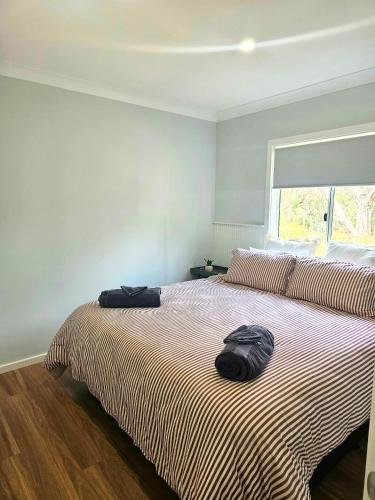 a bedroom with a large bed with a pillow on it at Parndana Hotel Cabins in Parndana