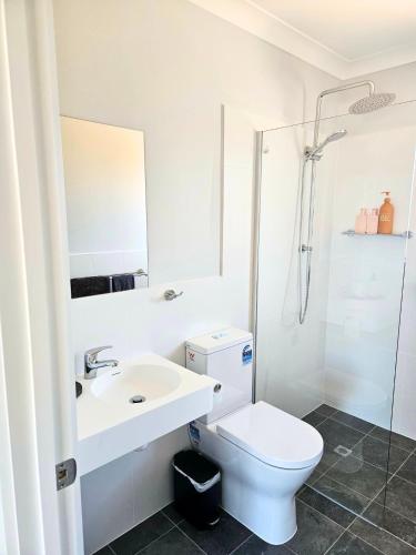 a bathroom with a toilet and a sink and a shower at Parndana Hotel Cabins in Parndana