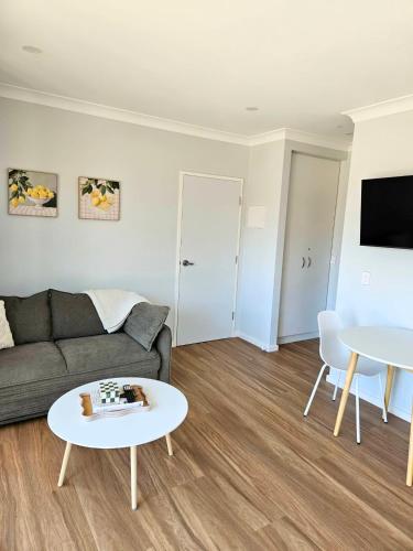 a living room with a couch and a table at Parndana Hotel Cabins in Parndana