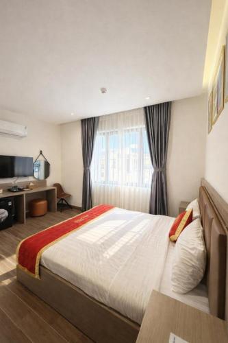 a bedroom with a large bed in front of a window at Hotel 168 Rạch Giá in Rạch Giá