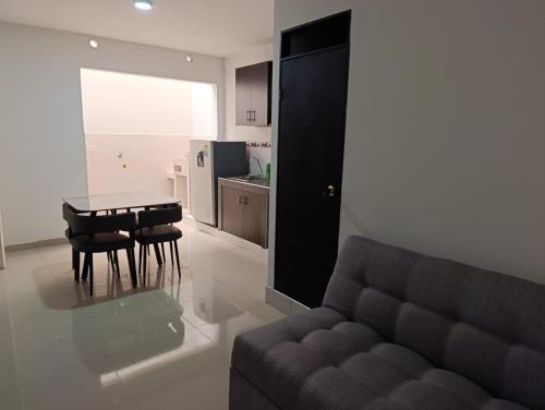 a living room with a couch and a table and a kitchen at Inmosolaris in Cali
