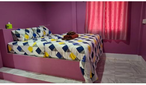 a bedroom with a bed with a teddy bear on it at Nasin House in Ko Bu Bu