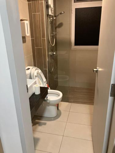a bathroom with a toilet and a shower at Simple and nice unit 3 bed 2 bath in Petaling Jaya