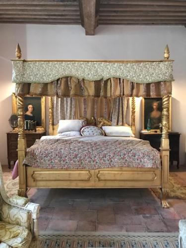 a bedroom with a large bed with a canopy at Chateau de Gudanes in Château-Verdun