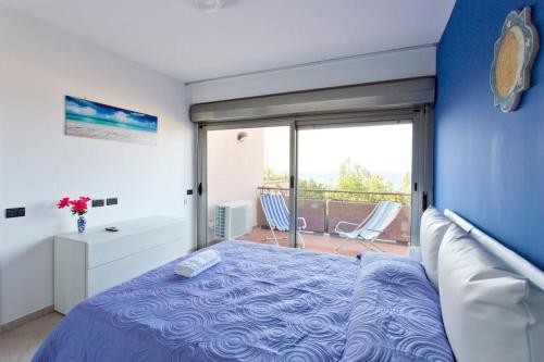 a bedroom with a bed and a balcony at Mondello Addaura Home Holiday in Mondello
