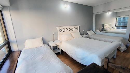 a bedroom with two beds and a window at Amazing View Studio Obelisco in La Porteña