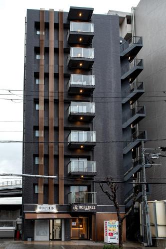 a building with balconies on the side of it at Hopetree 天王寺 in Osaka