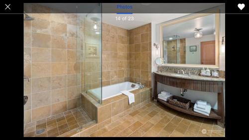 a bathroom with a tub and a sink and a mirror at Suncadia Lodge in Cle Elum