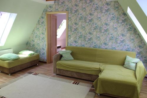 a living room with a couch and a window at Posthotel in Bad Bertrich