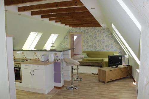a kitchen and a living room with a couch at Posthotel in Bad Bertrich