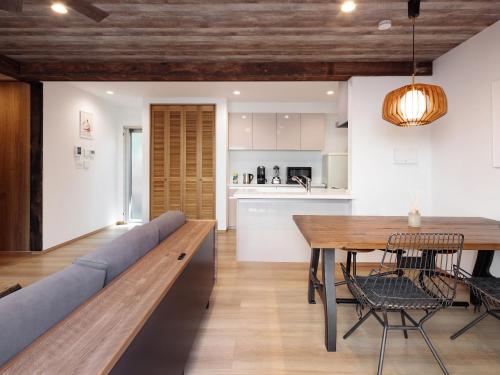 a kitchen and dining room with a table and a couch at -new-SHELL THE THIRD in Kamakura