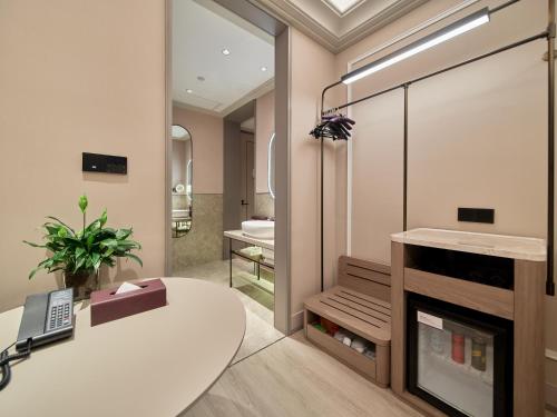 a bathroom with a white table and a phone at Mercure Beijing Universal Resort in Beijing