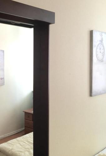 a bedroom with a bed and a clock on the wall at Linné Hostel in Gothenburg