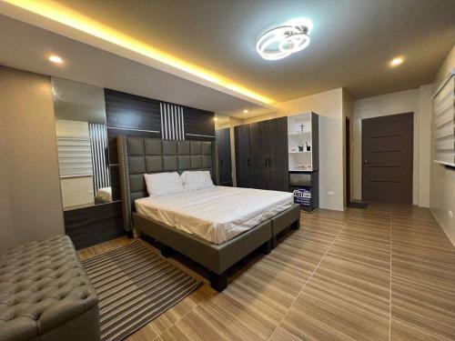 a bedroom with a bed and a couch in it at The Ginger Ville Private Resort in Lian