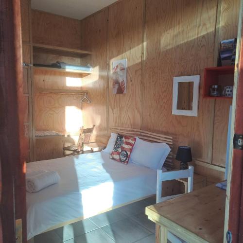 a bedroom with a white bed in a wooden wall at Alex's overnight in Heidelberg