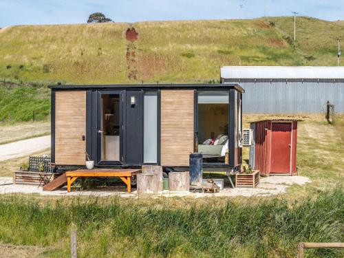 ein kleines Haus mit einer Couch und einem Tisch in der Unterkunft Perrys South by Tiny Away in Forth