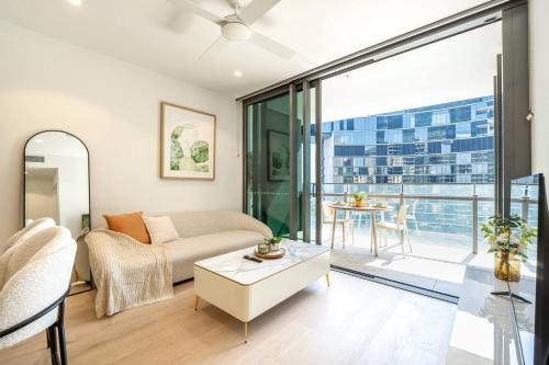a living room with a couch and a table at 1BR Queens Wharf City Charm with Balcony Views - LV 15 in Brisbane