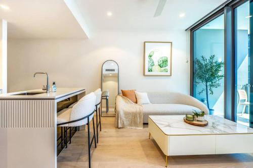 a living room with a couch and a table at 1BR Queens Wharf City Charm with Balcony Views - LV 15 in Brisbane
