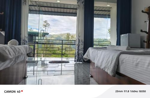 a bedroom with two beds and a large window at Why Not Guset House Ella in Ella