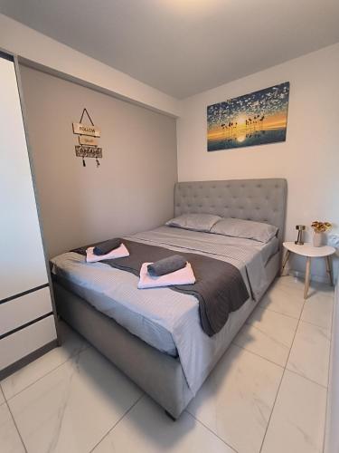 a bedroom with a bed with two towels on it at BmB apartments in Paralia Katerinis