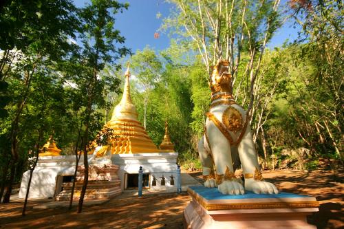 a statue of an elephant in front of a temple at River Kwai Jungle Rafts in Sai Yok