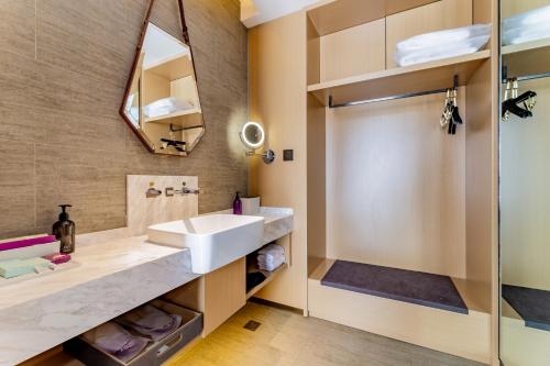 a bathroom with a sink and a shower at Mercure Huhhot Economic Zone in Hohhot