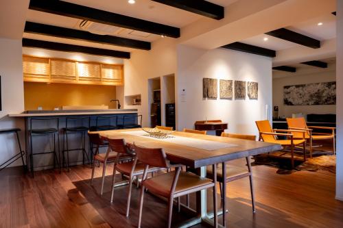 a kitchen with a large wooden table and chairs at Rairin in Hiroshima