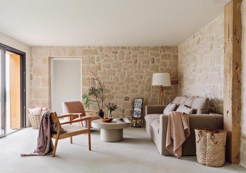 a living room with a couch and a table at GiteLaGrange in Lalanne-Arqué