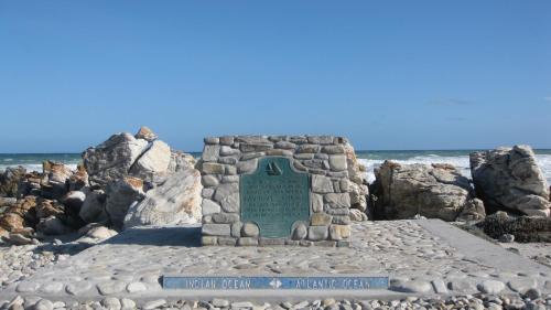 a monument on the beach with the ocean in the background at Agulhasbestview in Agulhas